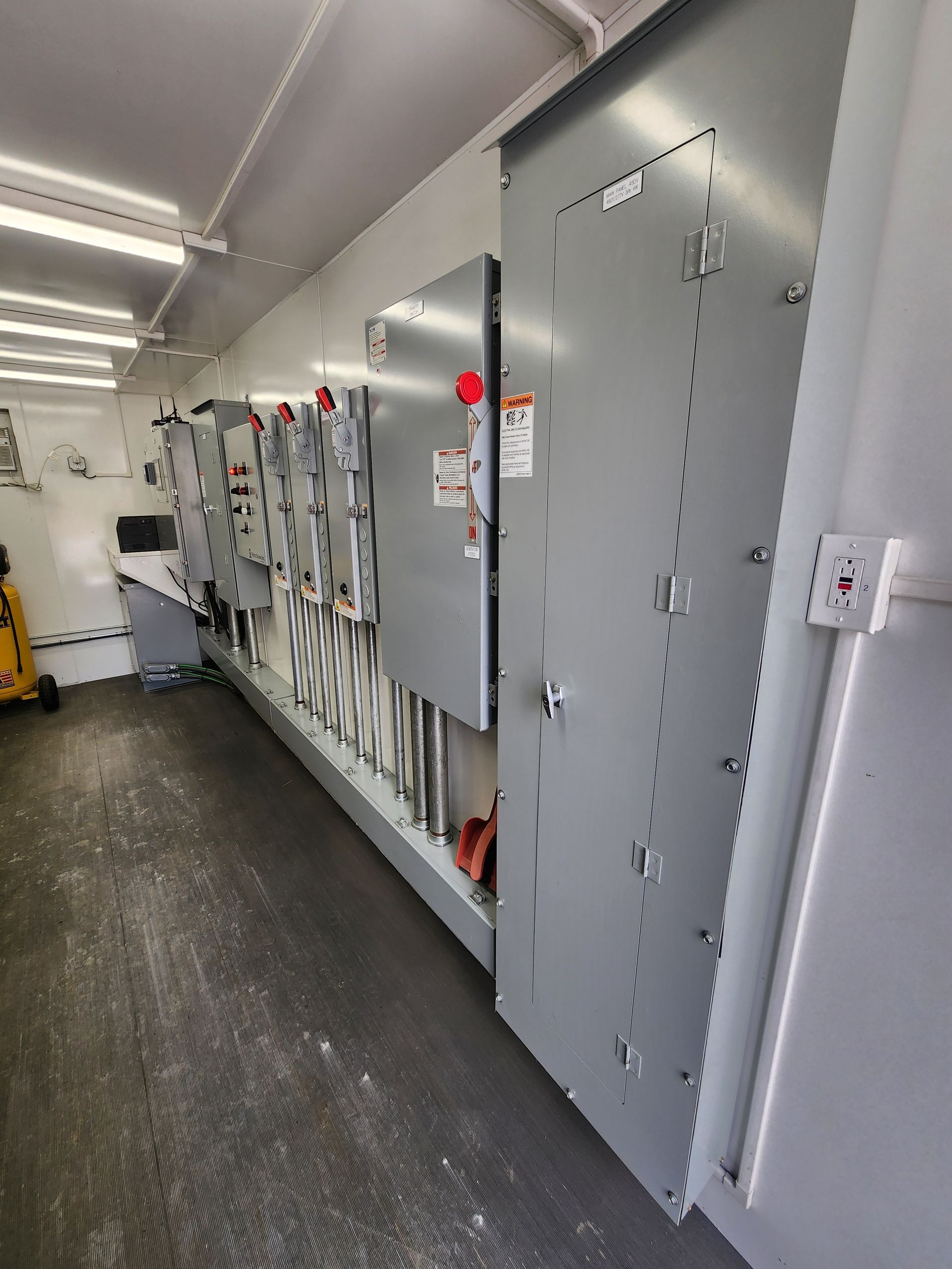 A man is fixing a light switch on a table.
