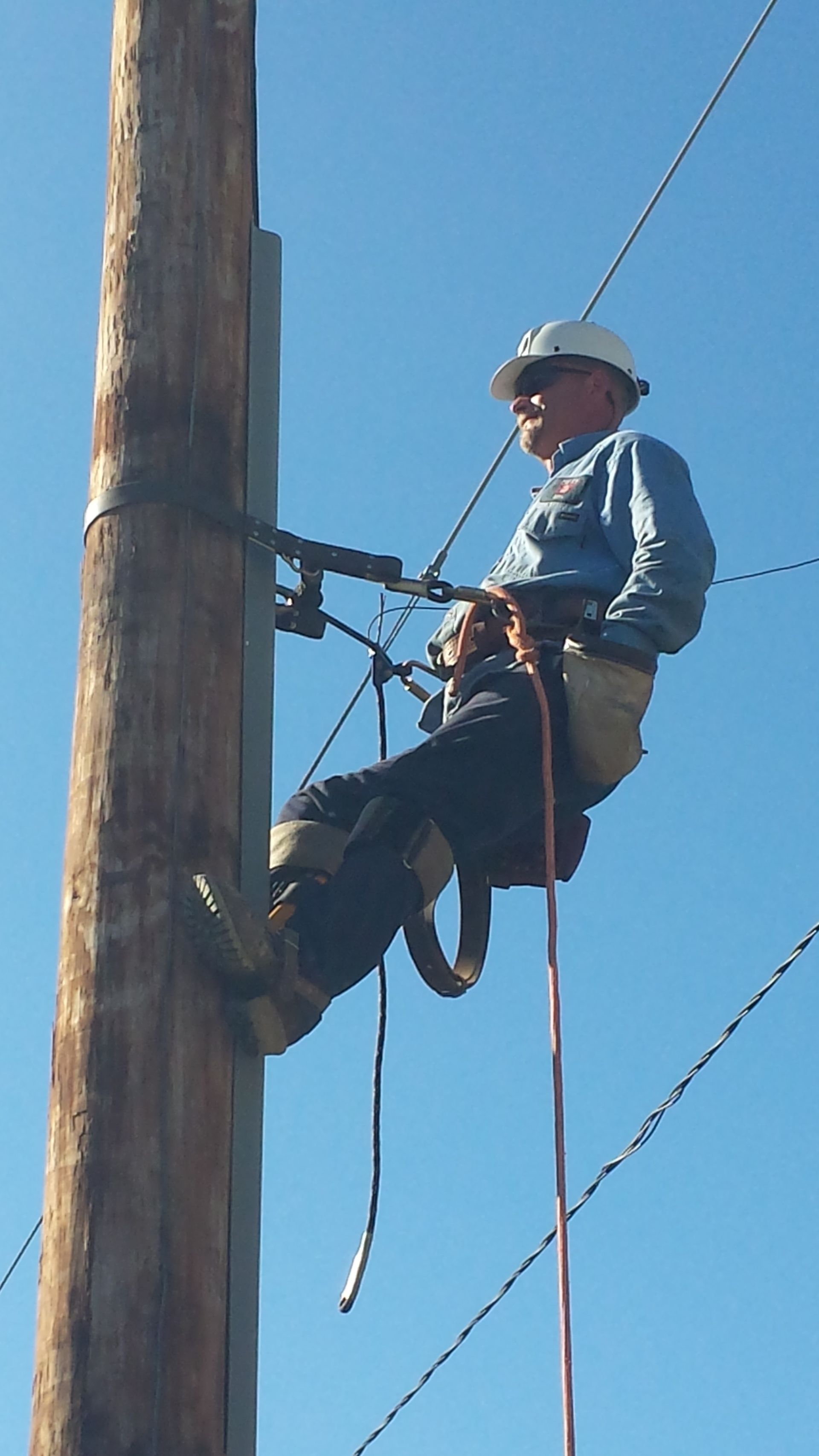 A man is holding a roll of wire in a room.