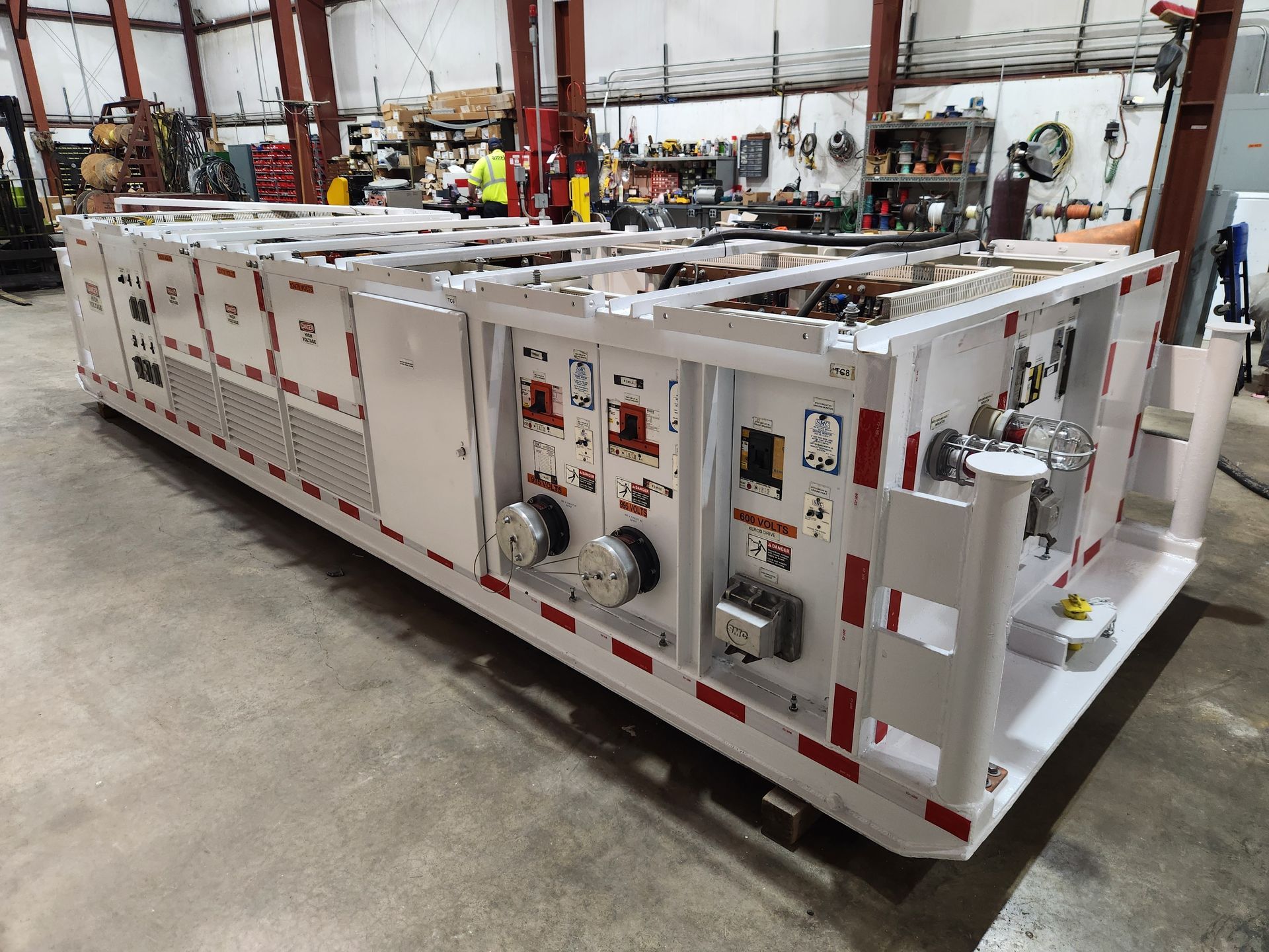A man is working on a server in a server room.