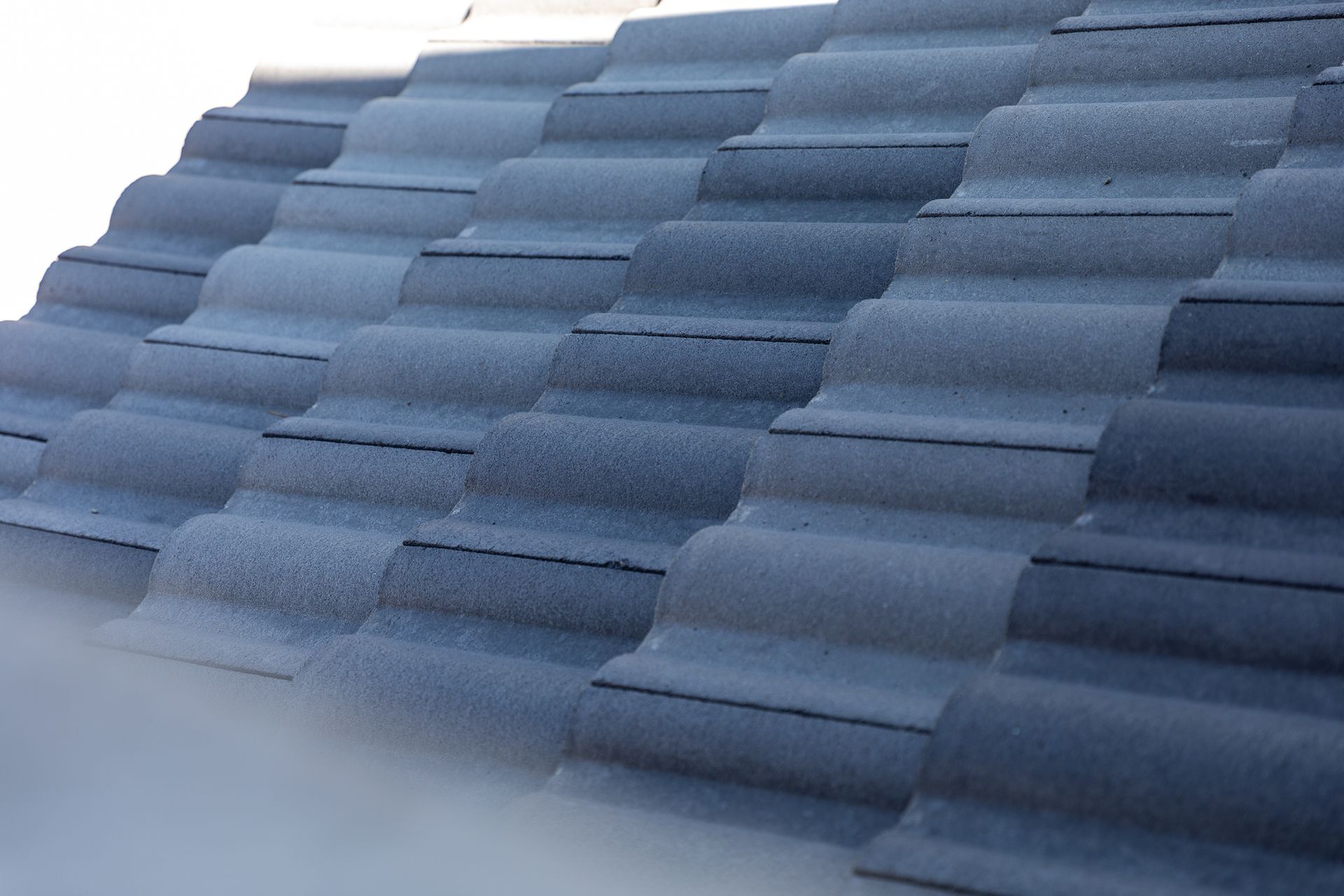 a close up of a gray tile roof