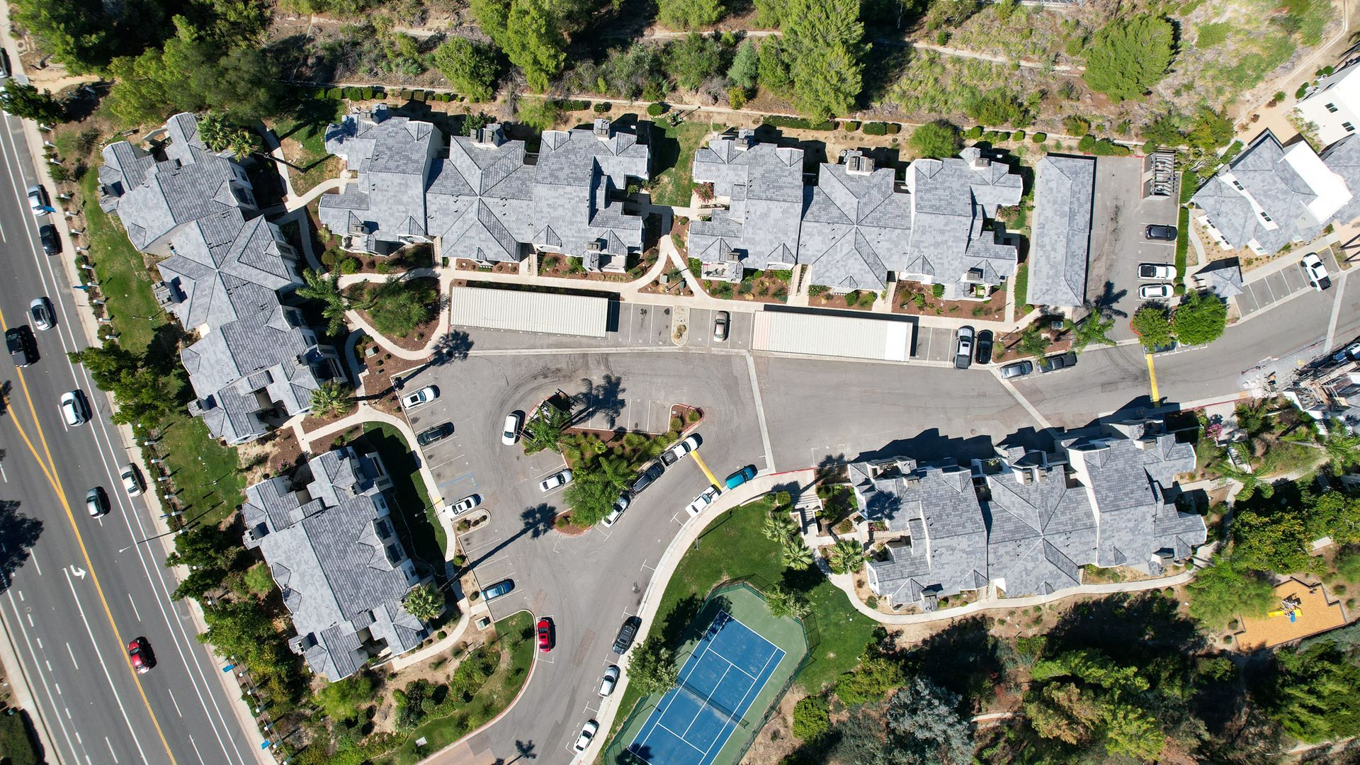 an aerial view of a residential area with a tennis court