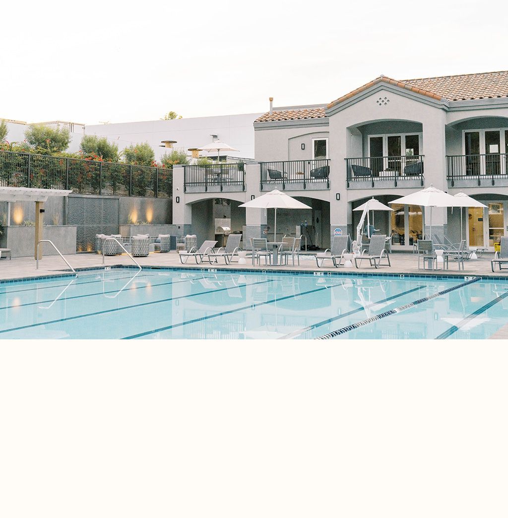 A large house with a swimming pool in front of it