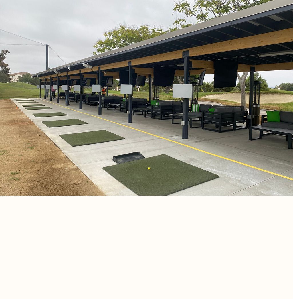 a row of green mats with a golf ball on one of them