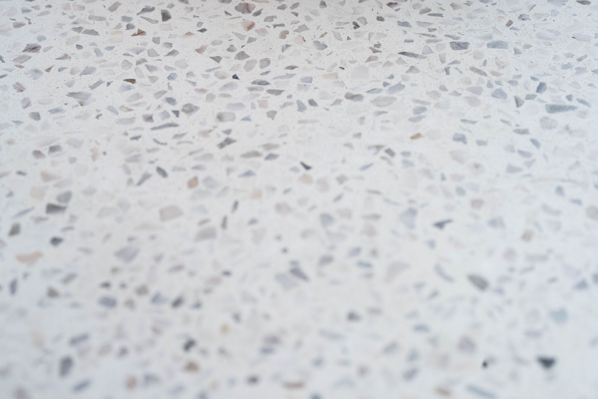 a white surface with a lot of small rocks on it