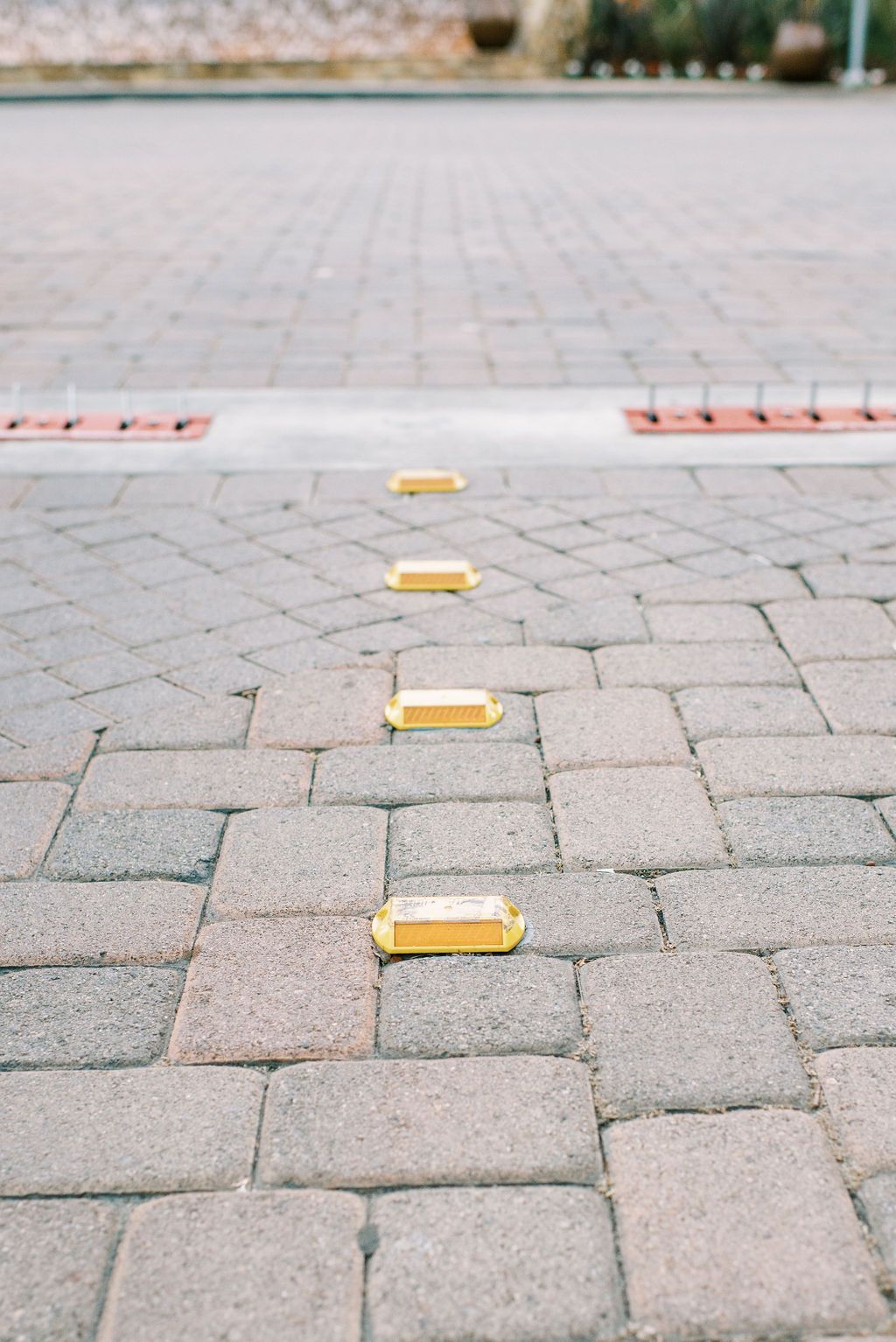 a row of yellow bricks on a brick pavement