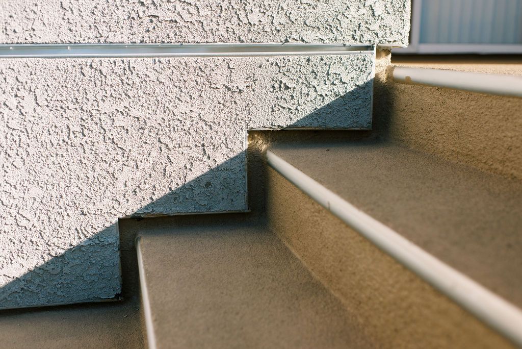 a close up of a staircase with a white railing