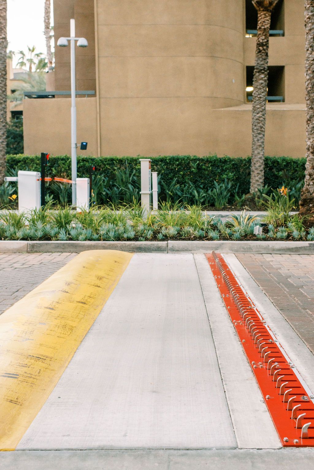 a parking lot with a yellow line and a red barrier