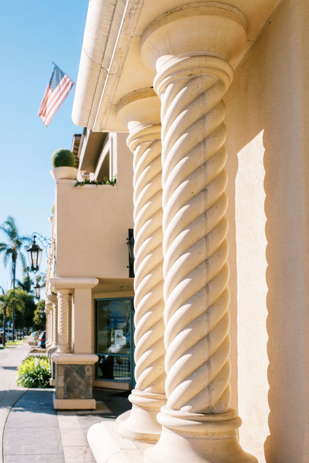 a building with twisted columns and an american flag
