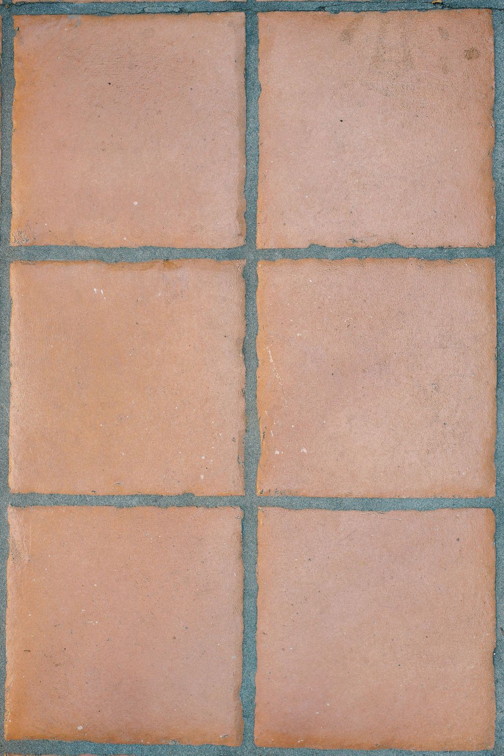 a close up of a brick floor with a blue border