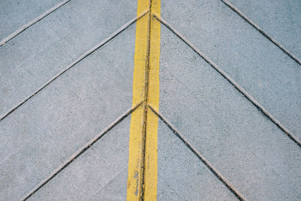 a yellow line is painted on a concrete surface