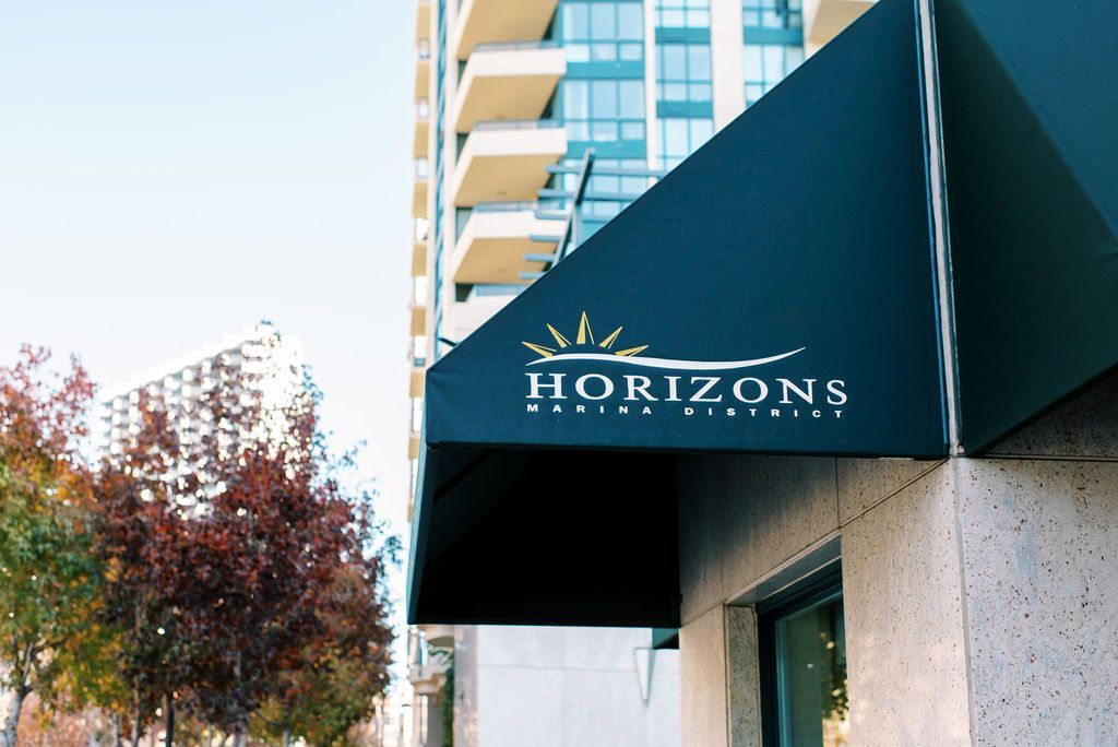 a black awning with horizons marina district written on it