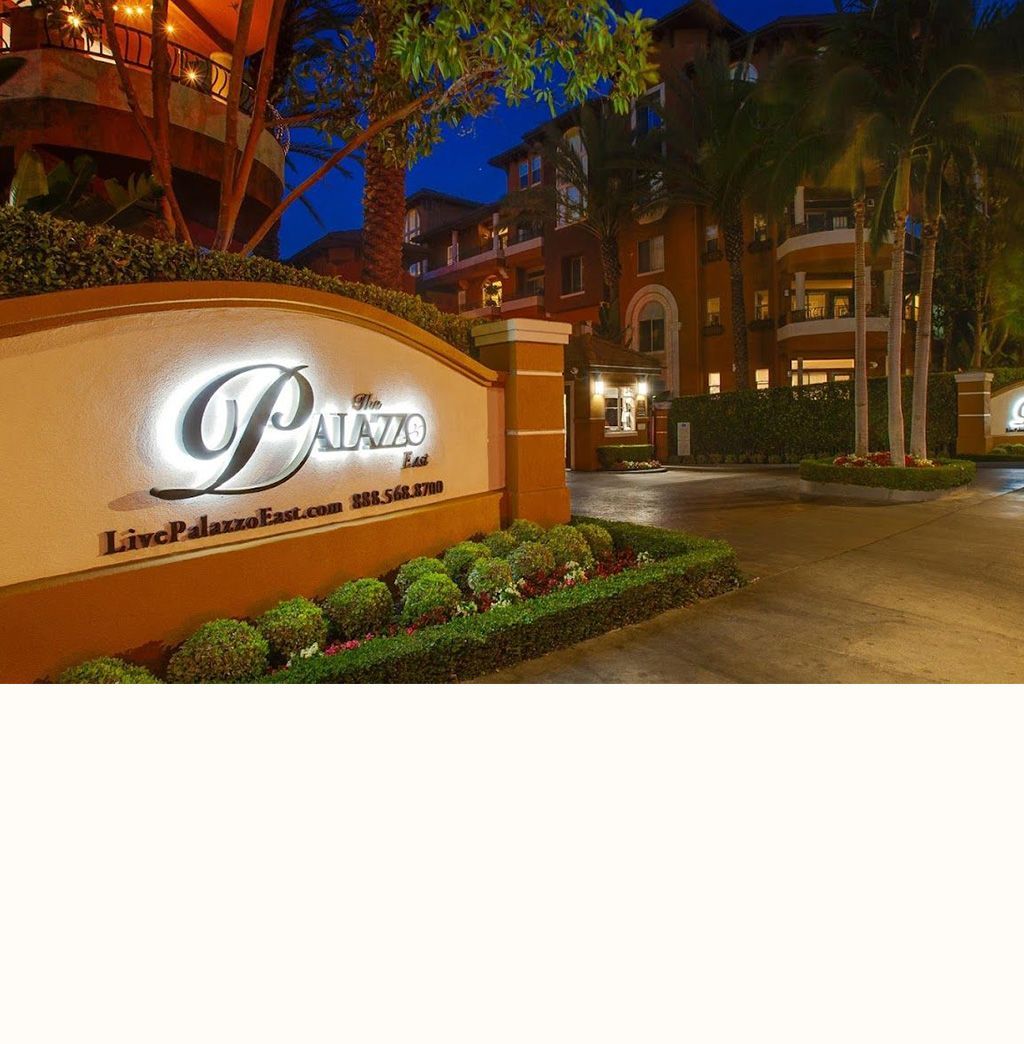 A sign for the palazzo is lit up at night