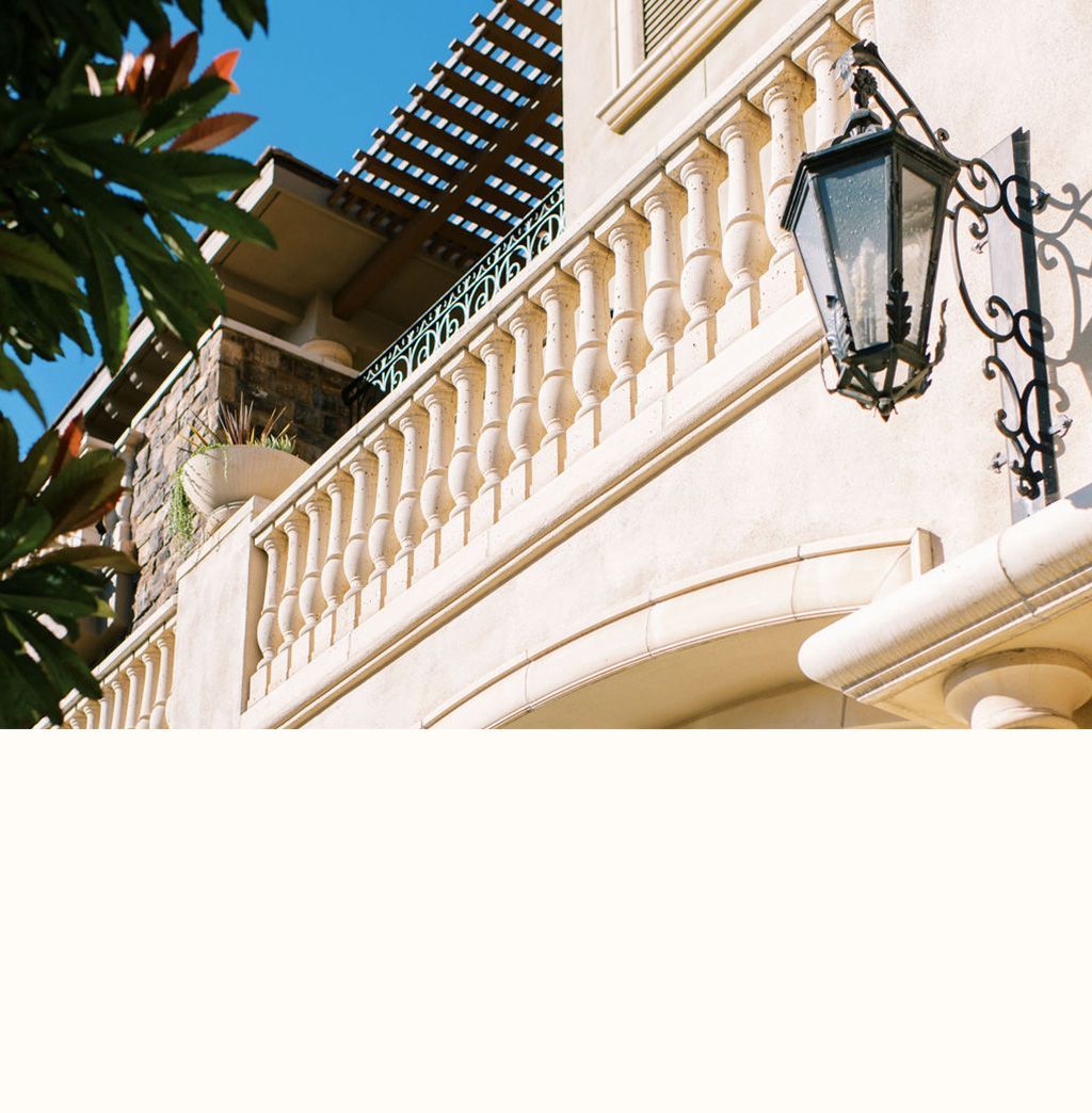 A building with a balcony and a lamp on the side