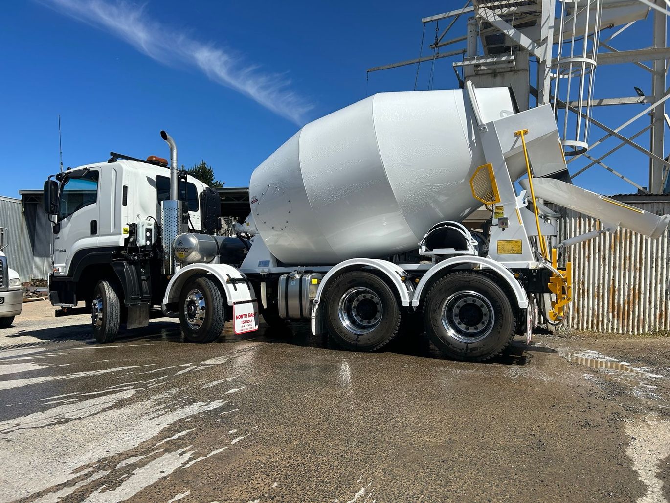 A concrete mixer truck is parked in a parking lot.