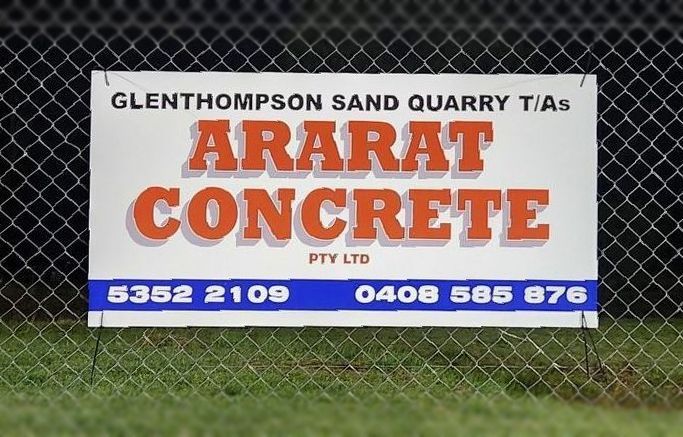 A fence with a sign that says ' arajat concrete ' on it