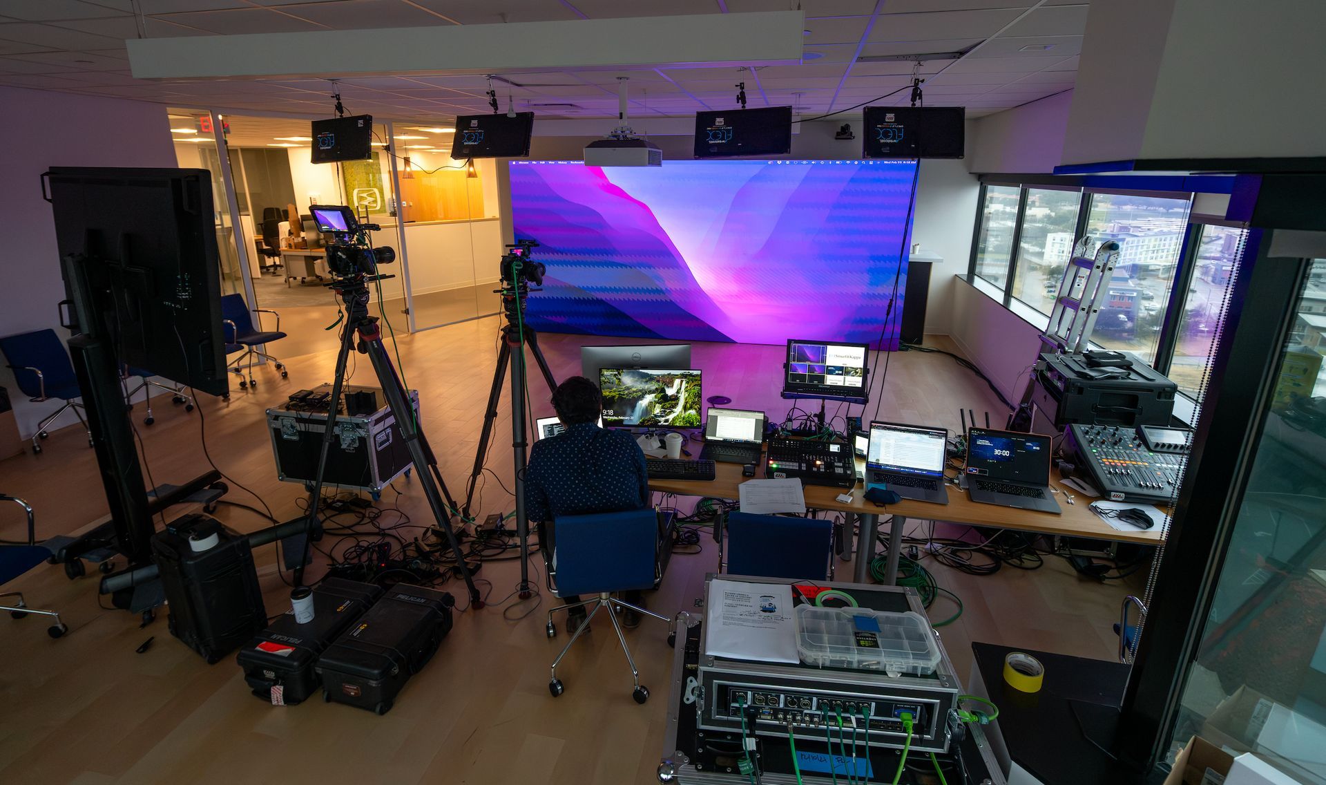 Behind-the-scenes production workspace supporting a multi-camera corporate livestream.