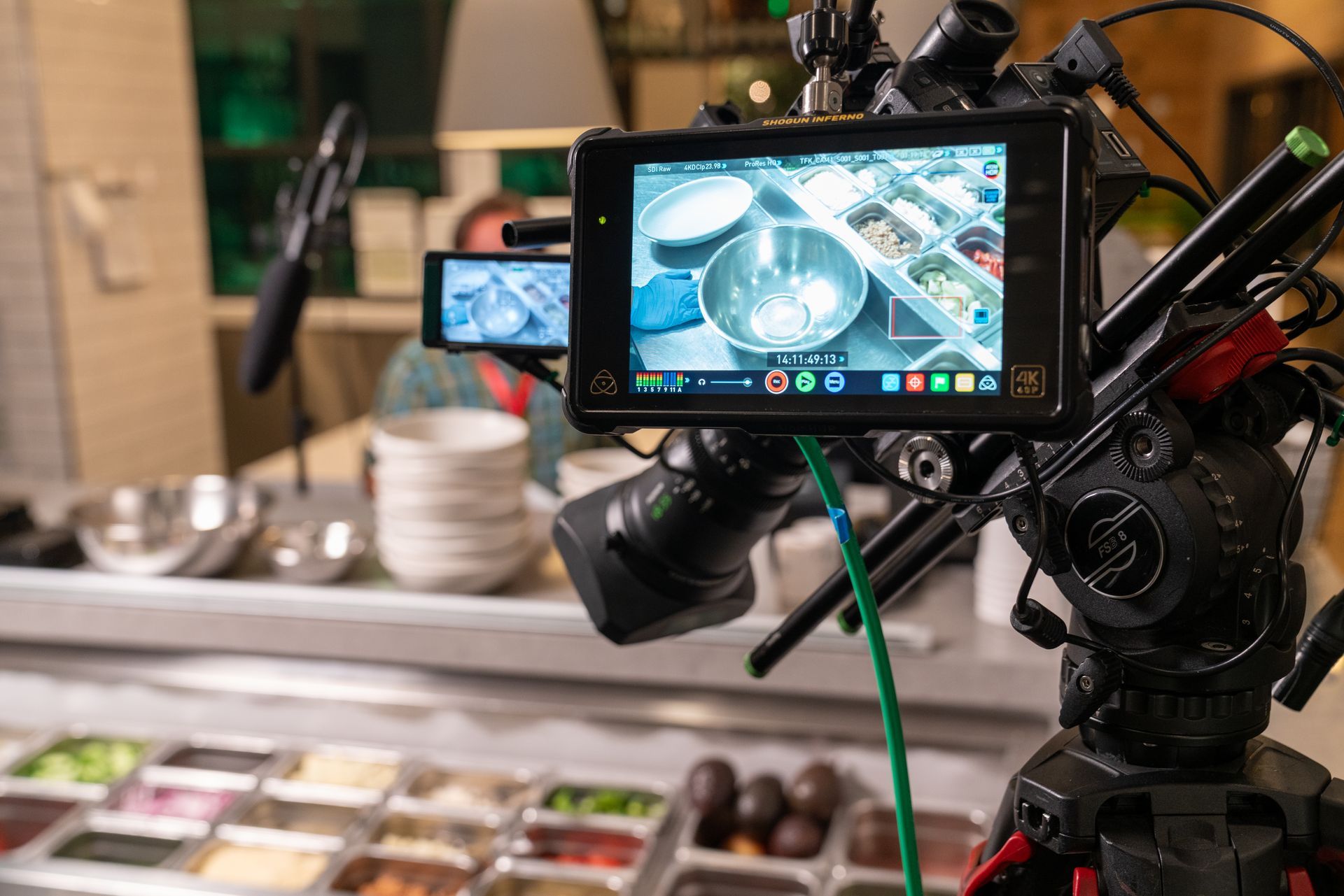 Behind-the-scenes video production capturing a chef during a branded culinary experience.