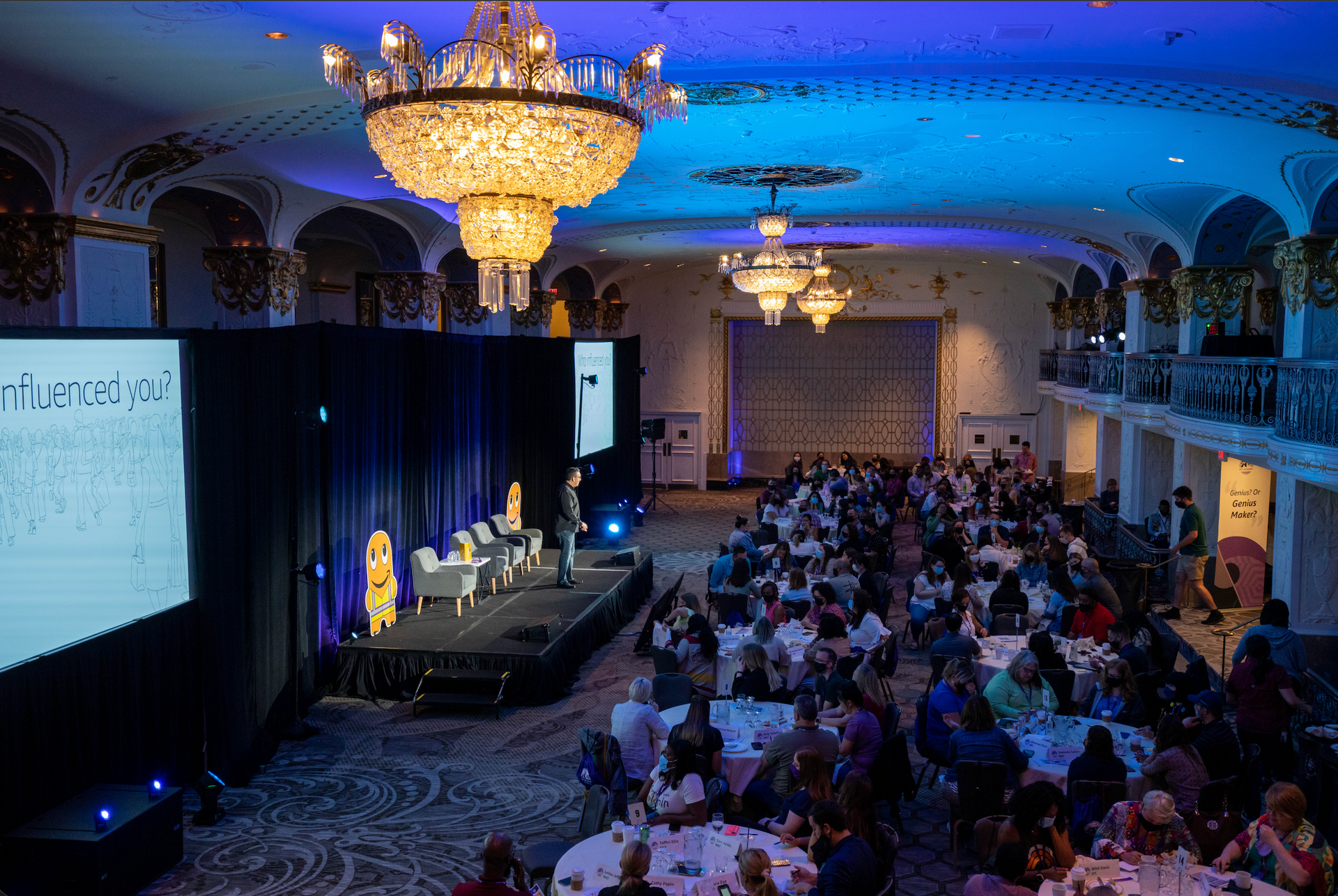 Professional event photography capturing a keynote presentation and engaged audience during a corporate conference.