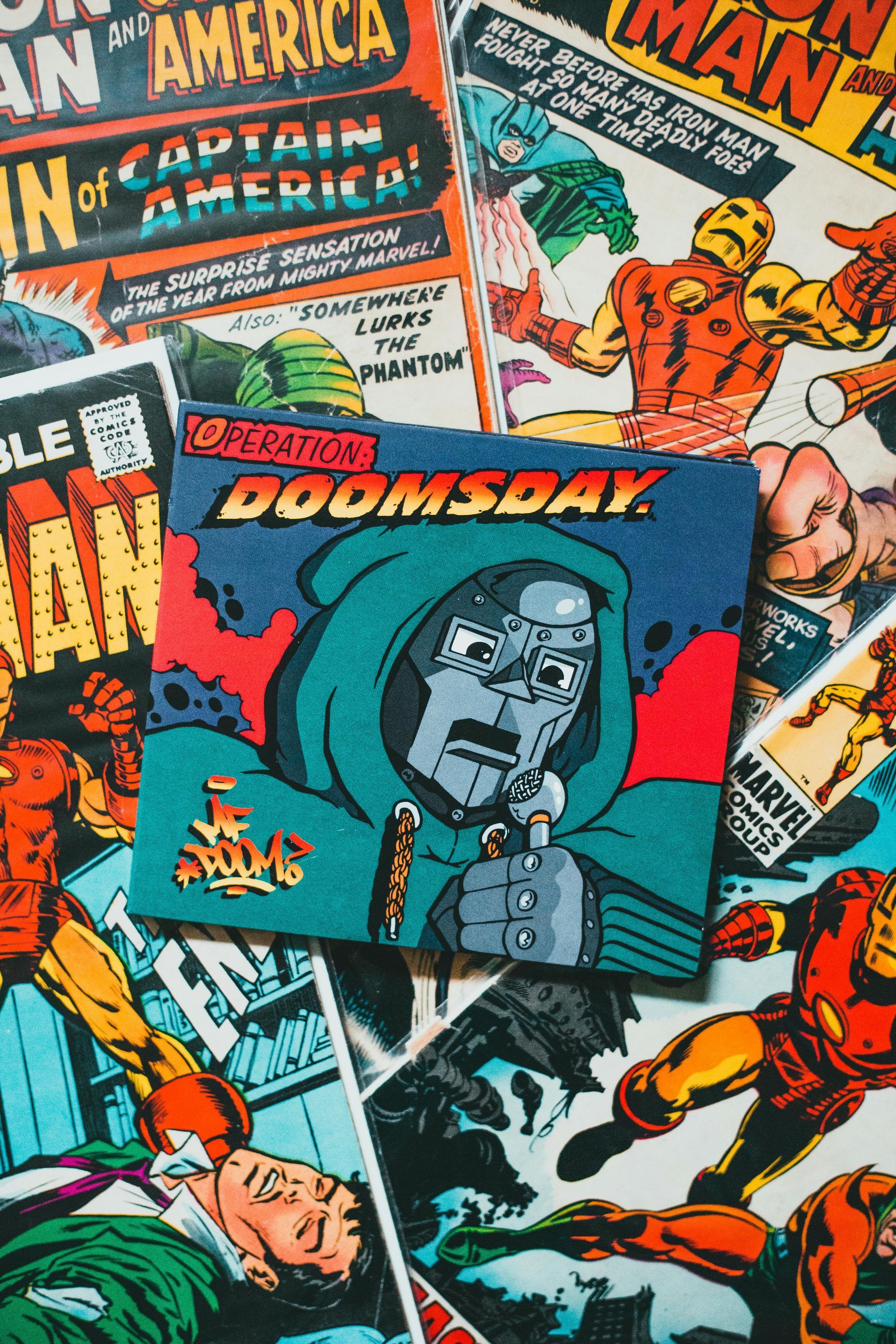 A bunch of comic books are stacked on top of each other on a table.