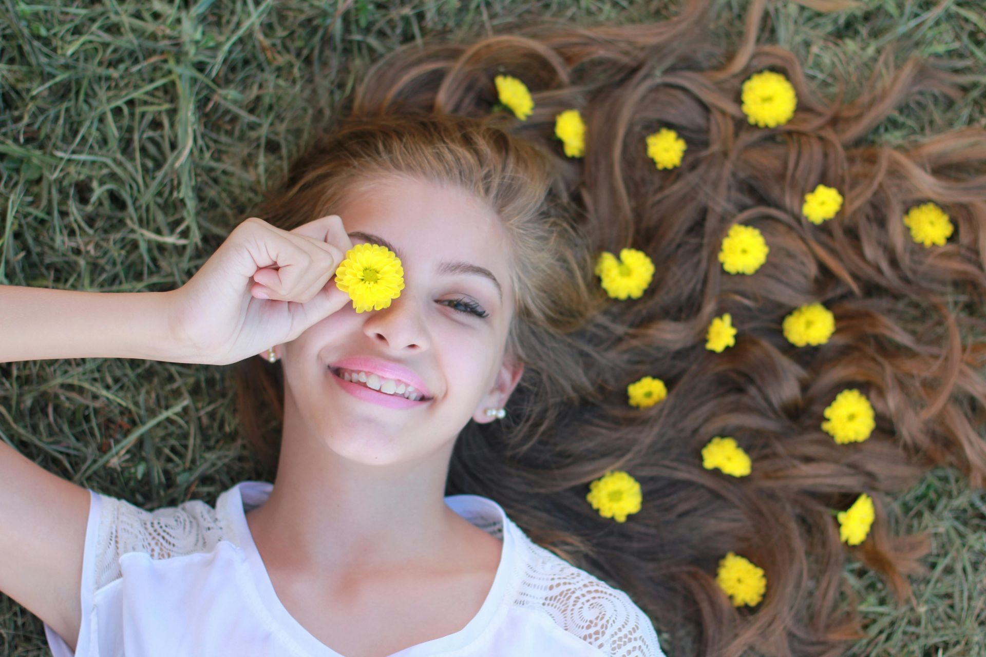 A woman with colorful clips is smiling.