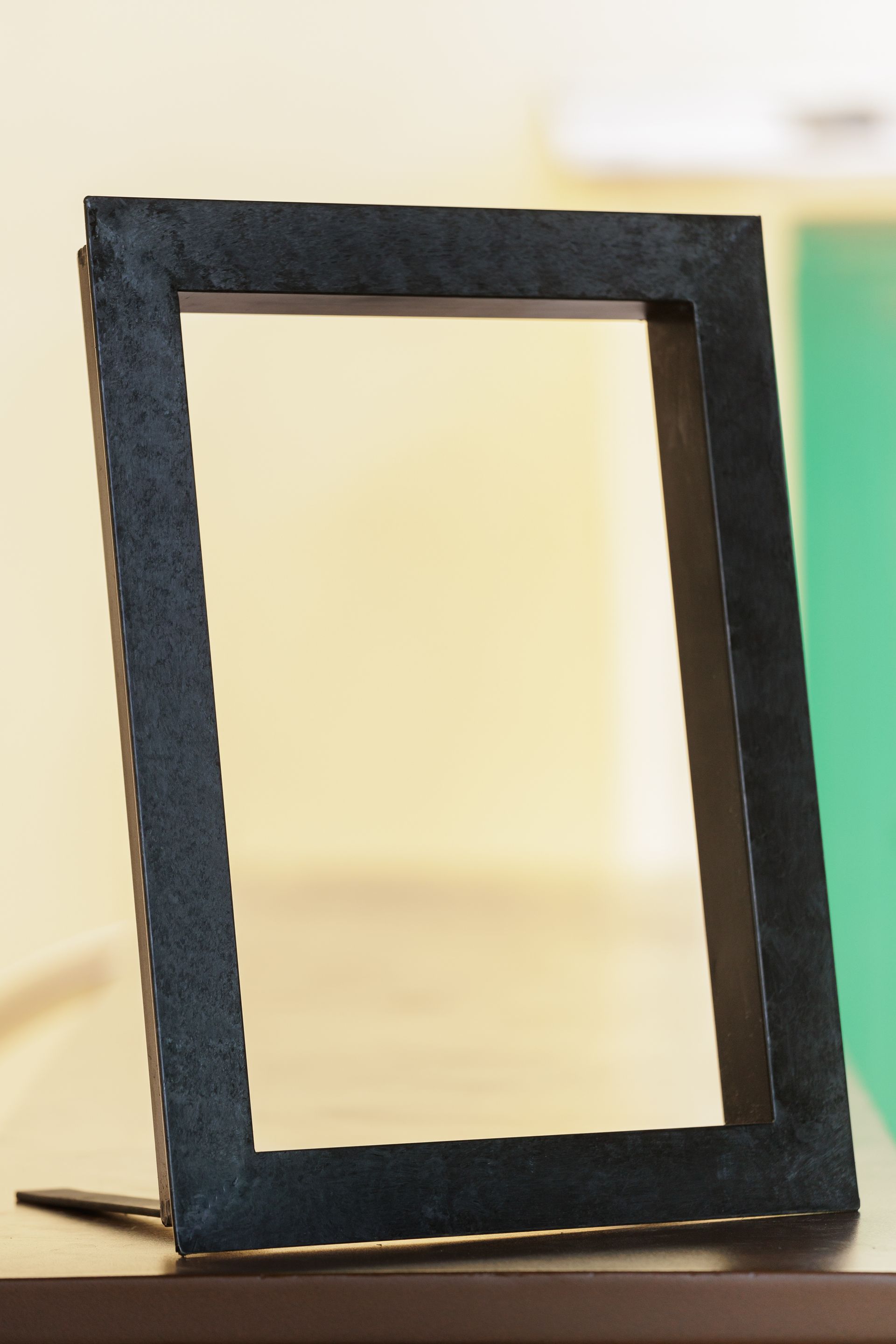 Una cornice nera è appoggiata su un tavolo