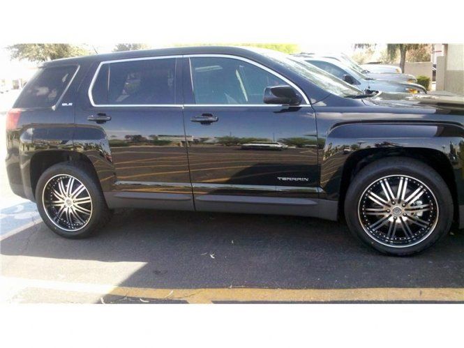 A black suv is parked in a parking lot.