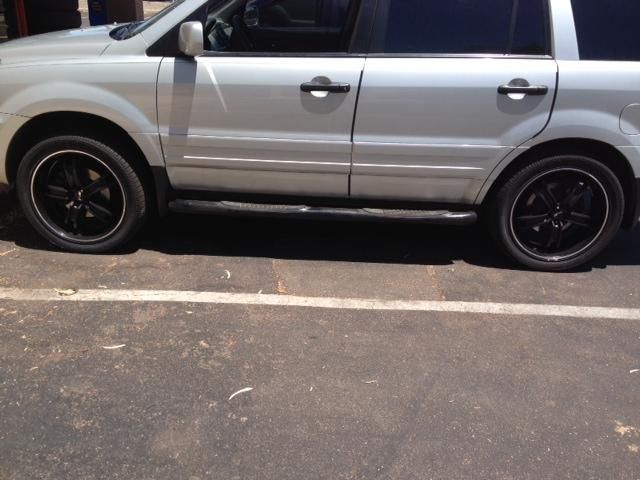 A silver suv is parked in a parking lot