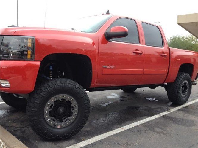 A red truck is parked in a parking lot