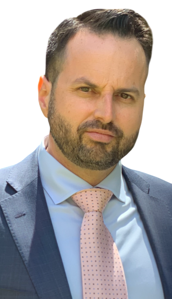 A man with a beard is wearing a suit and tie.