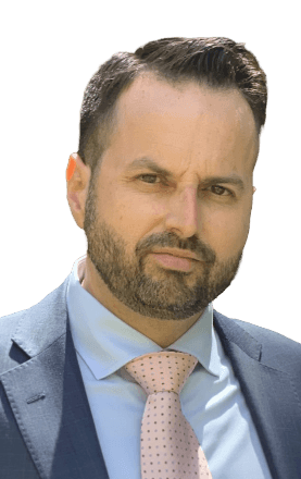A man with a beard is wearing a suit and tie.