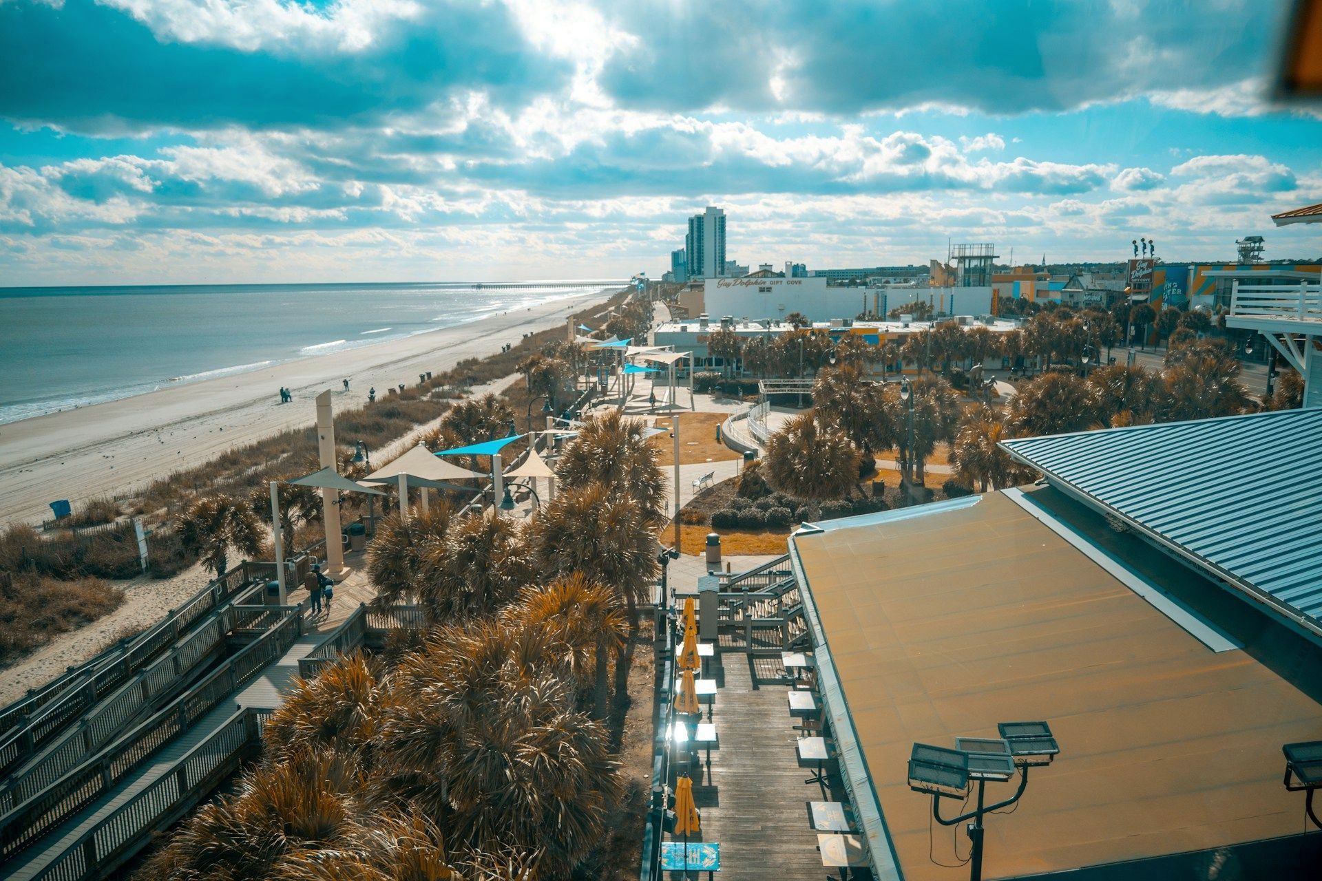 An aerial view of a beach and a city from a ferris wheel.