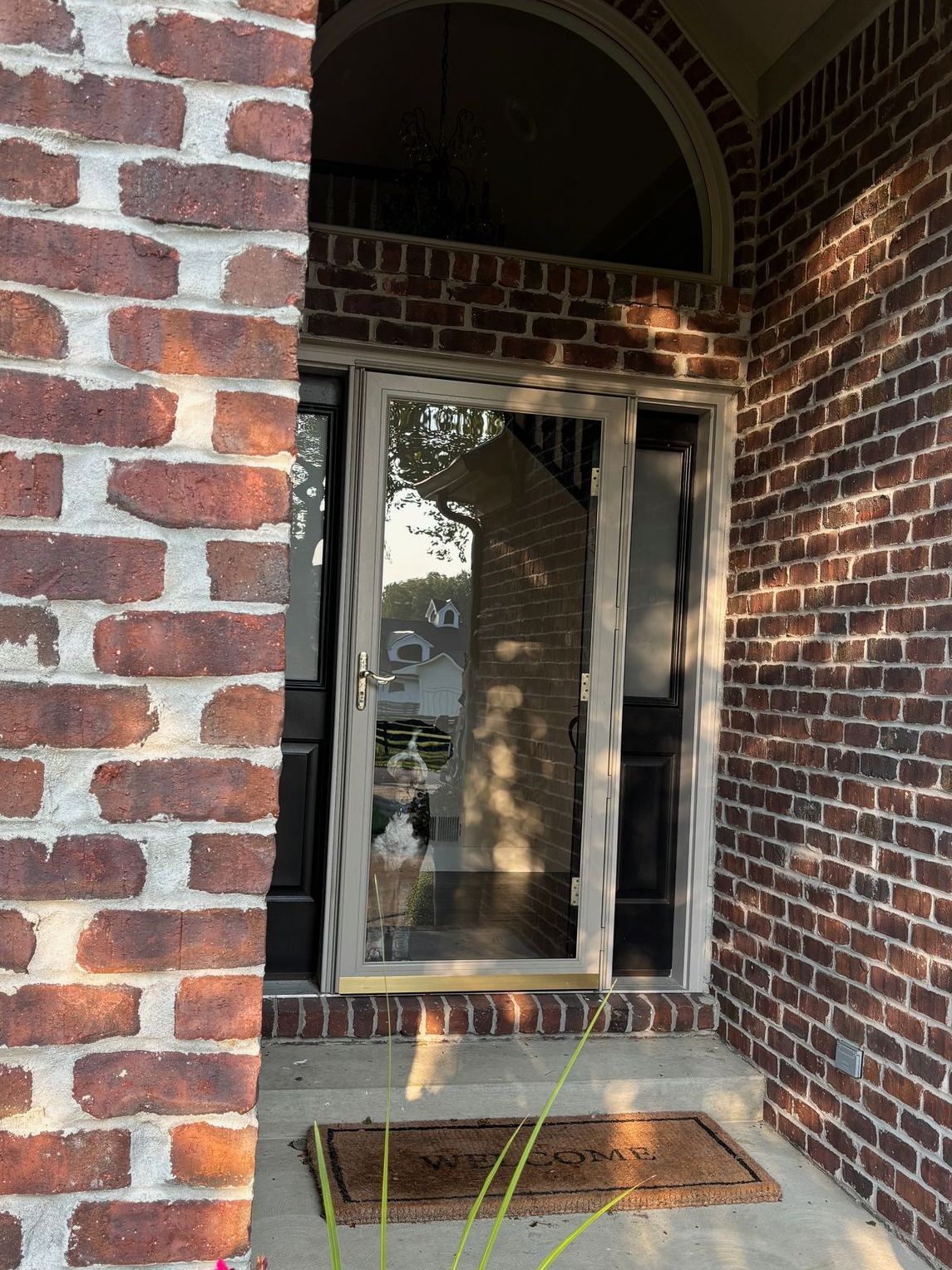 A brick building with a sliding glass door.