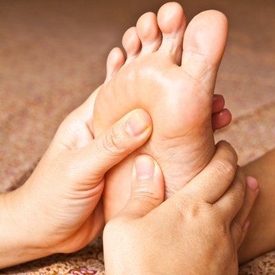 A person is giving another person a foot massage