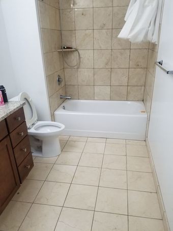 A bathroom with a toilet a bathtub and a shower