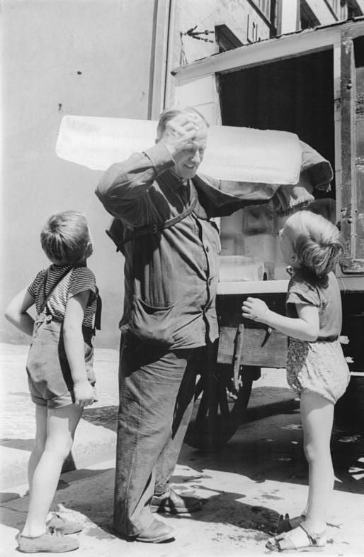 A black and white photo of a man and two children