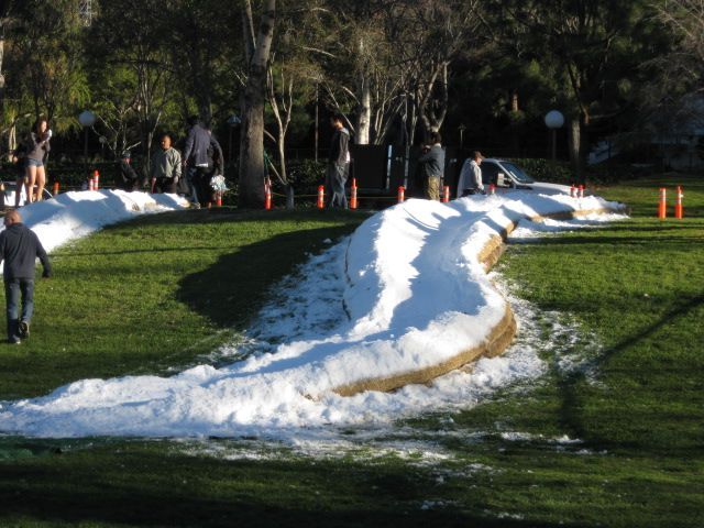 A man walking in a park with snow on the ground