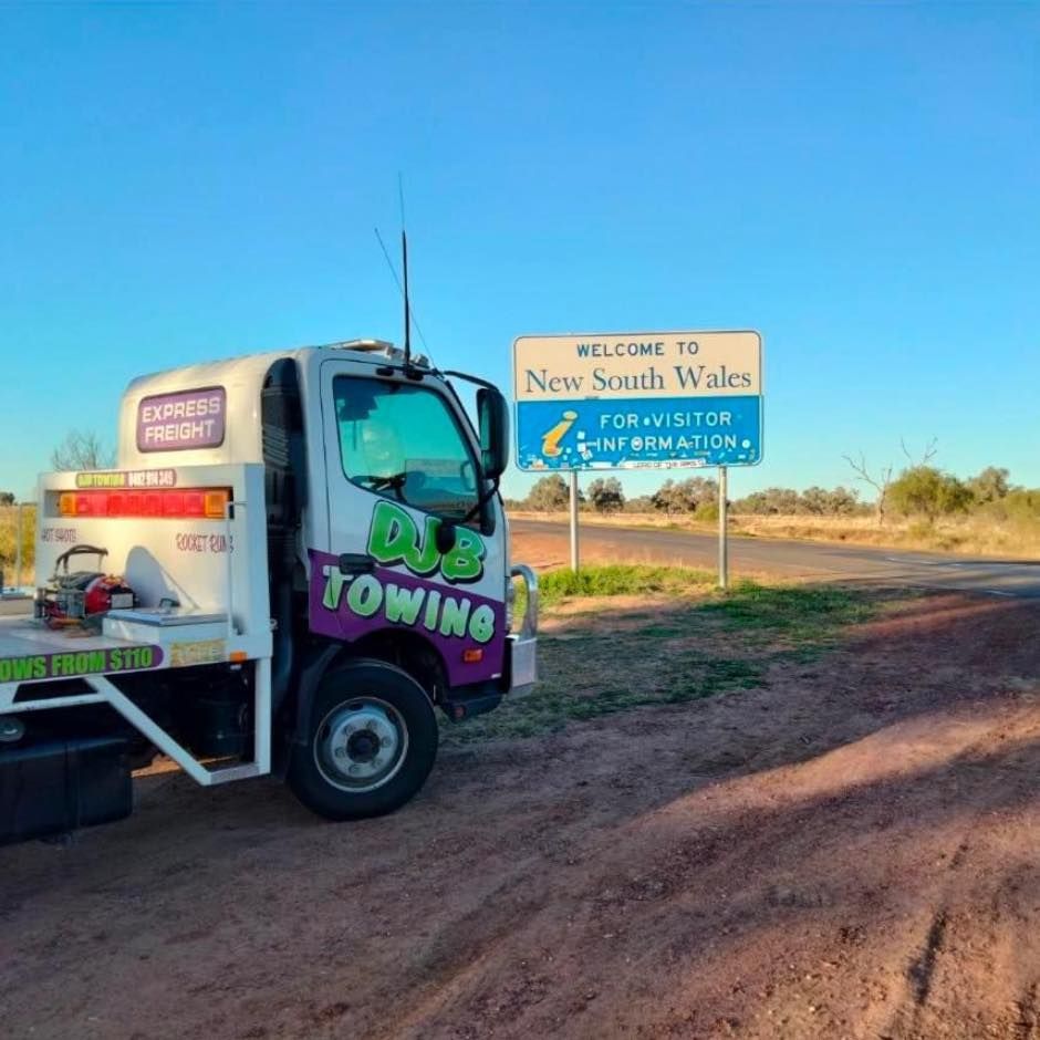 A Towing Truck Is Parked in Front of A Sign — Hot Shots 2 U In Townsville, QLD