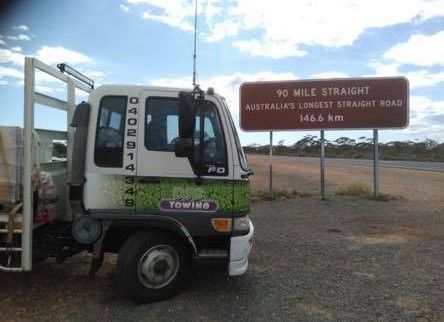 Truck Parked Beside Sign for 90 Mile Straight — Hot Shots 2 U In Townsville, QLD