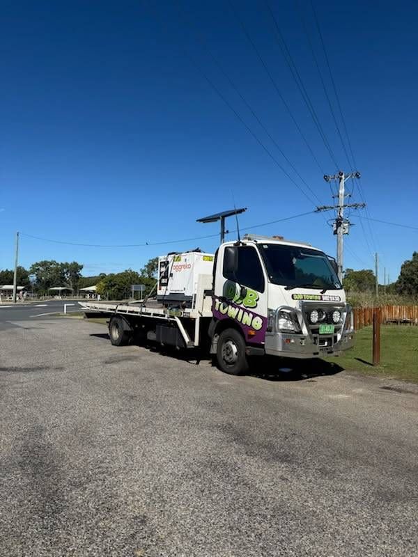 White Tow Truck With Green Accents Parked on Asphalt — Hot Shots 2 U In Townsville, QLD