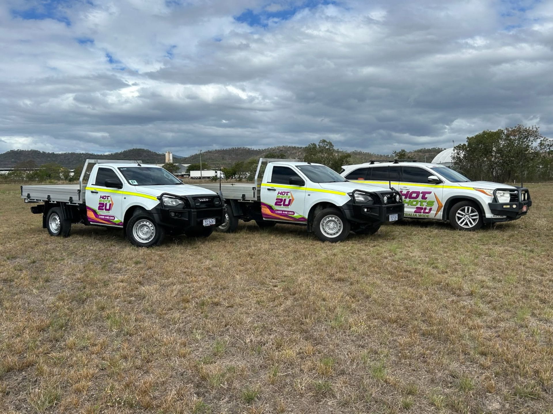 Three White Work Trucks With Colorful Logos — Hot Shots 2 U In Townsville, QLD