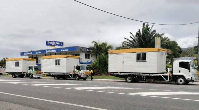 Three White Cabins With Yellow Roofs Being Transported — Hot Shots 2 U In Townsville, QLD