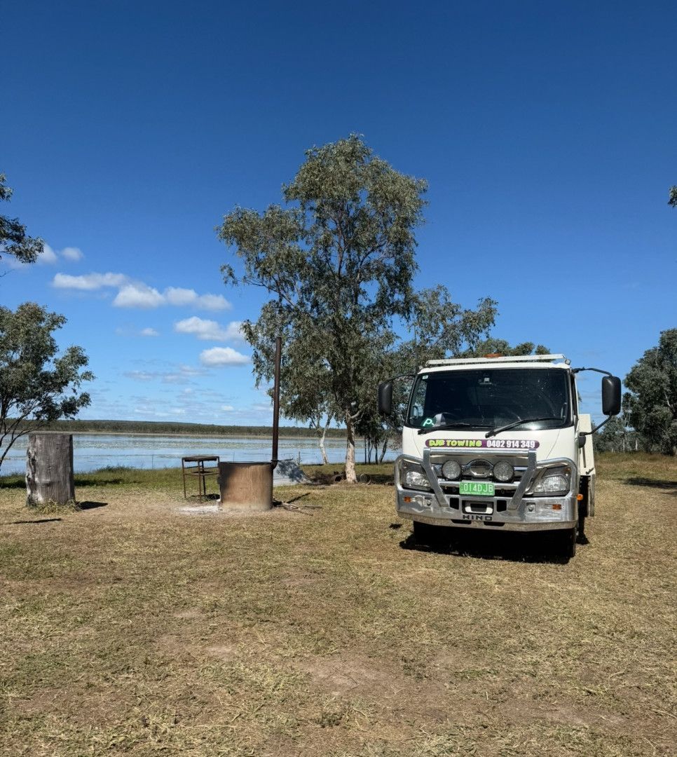 A Tow Truck with A Generator on The Back Is Parked on The Side of The Road — Hot Shots 2 U In Townsville, QLD