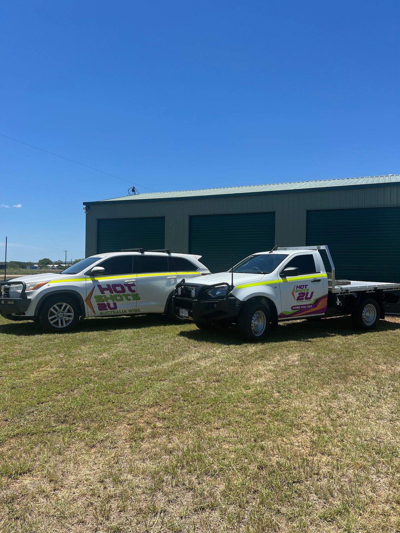 A car and a ute with grass and sky in the background — Hot Shots 2 U In Townsville, QLD