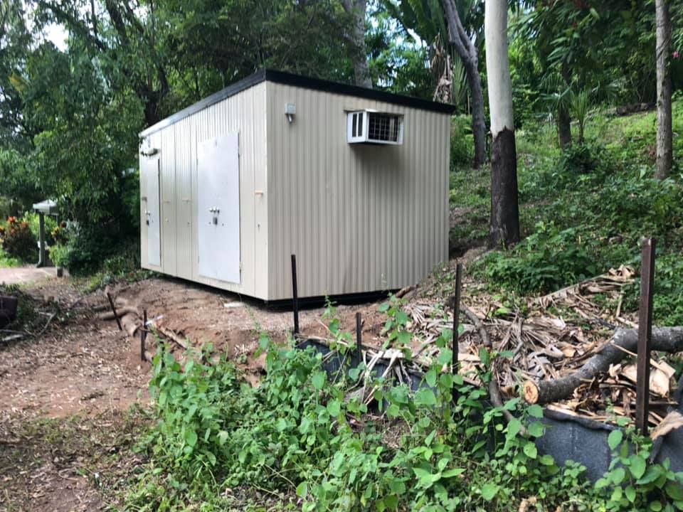 Tan Utility Building With White Doors, Air Conditioner — Hot Shots 2 U In Townsville, QLD