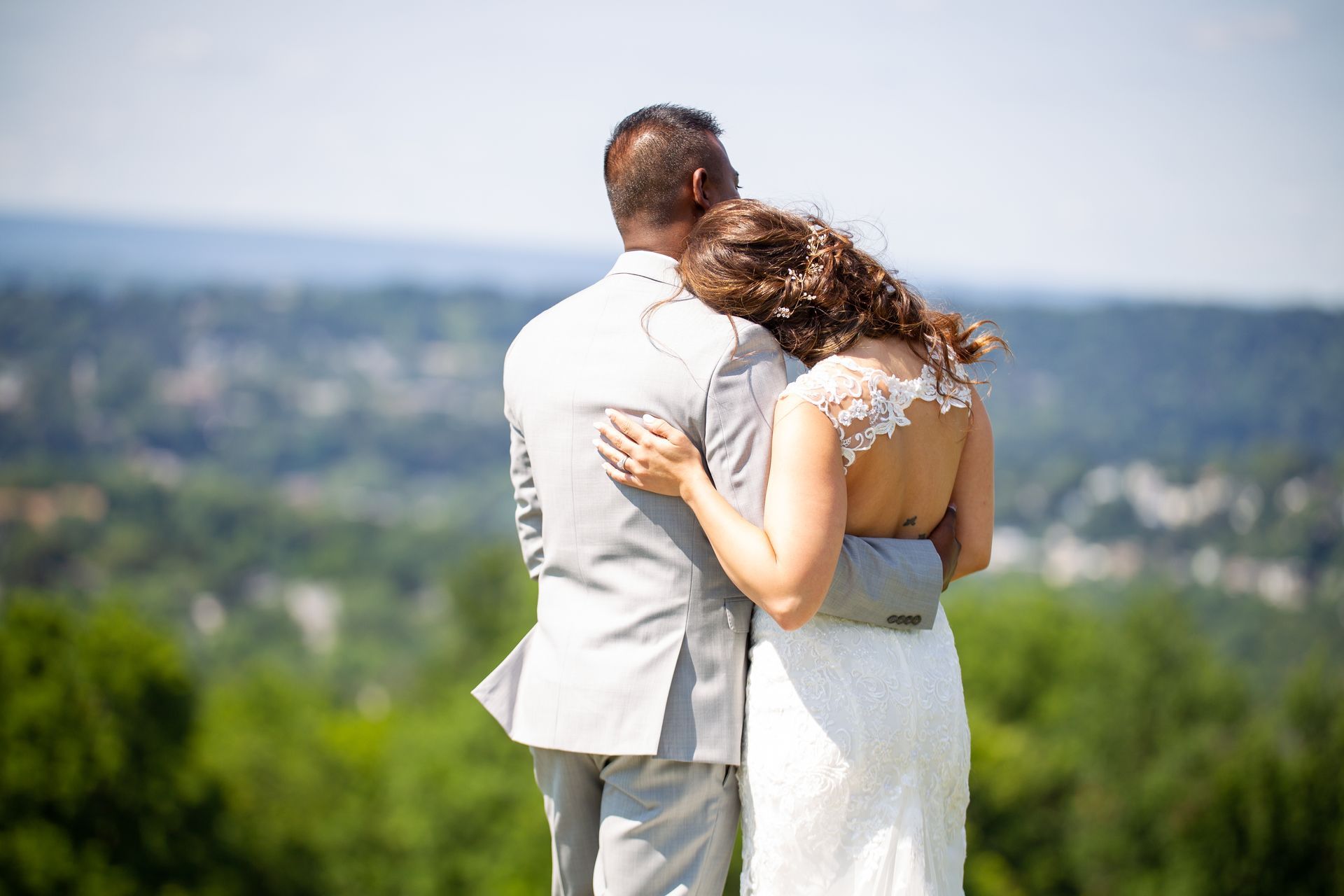 A a photo of a bride and groom standing next to each other in a field taken by Ever After Studio.