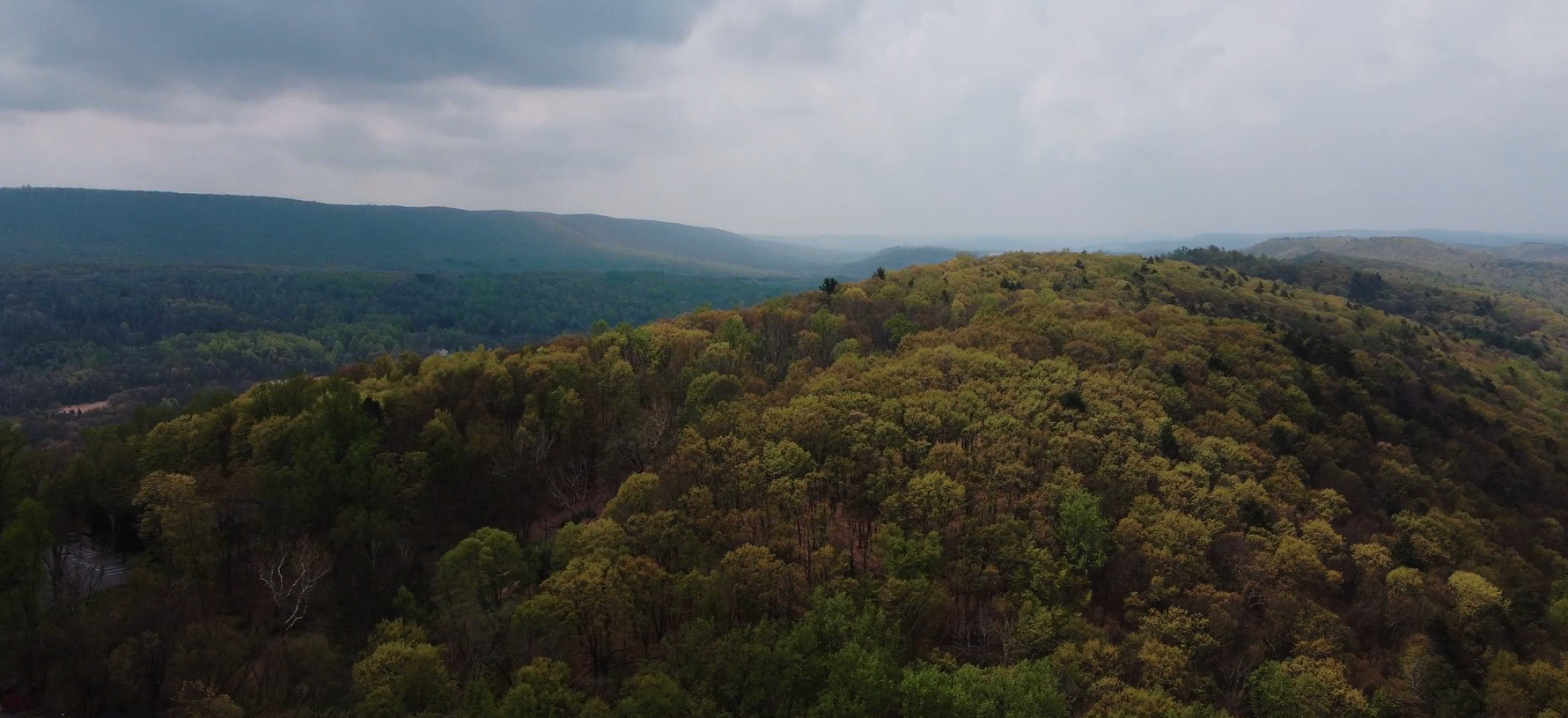 Drone overview of the Pocono Mountains during the day by Ever After Studio