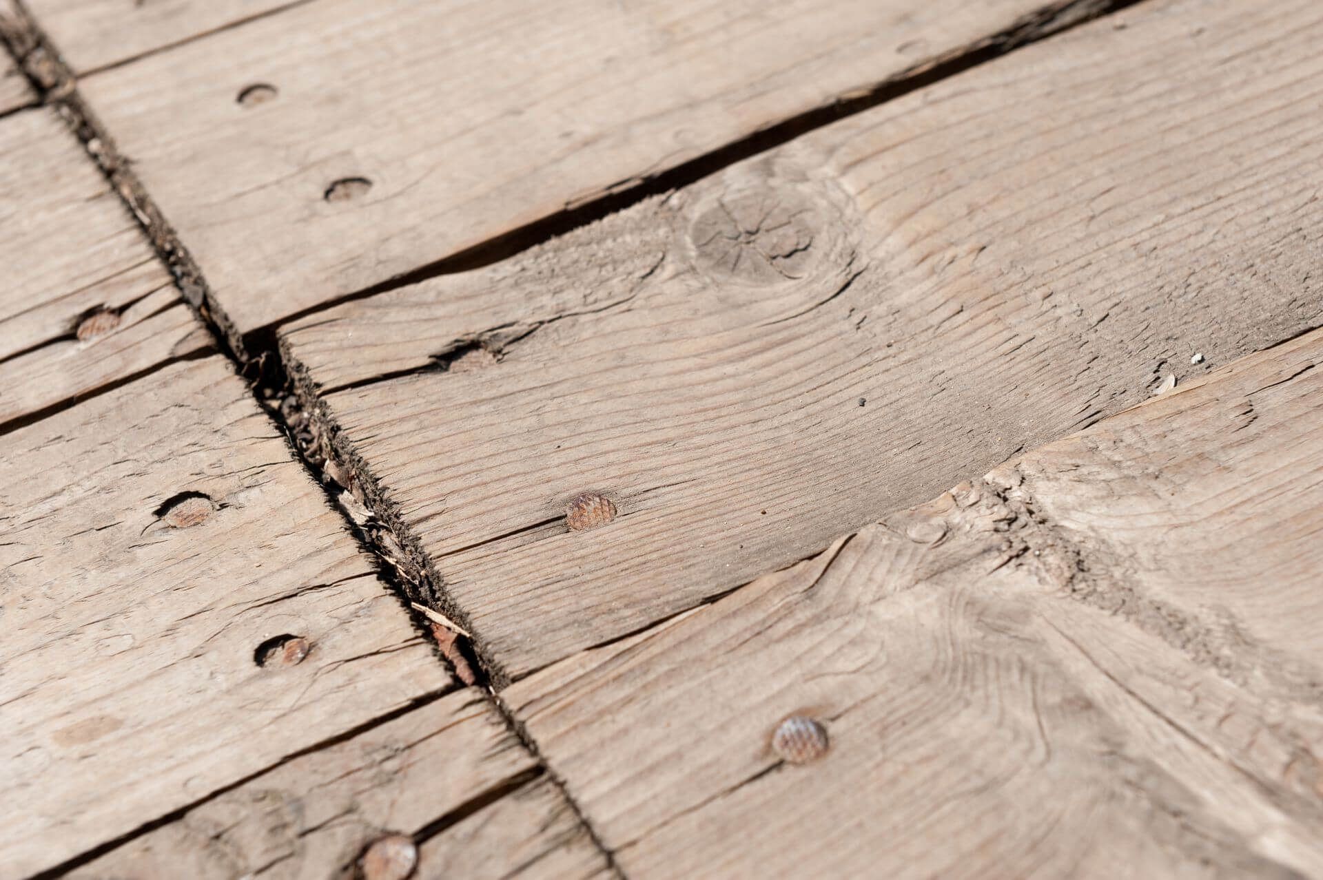 A close up of a wooden warped deck.