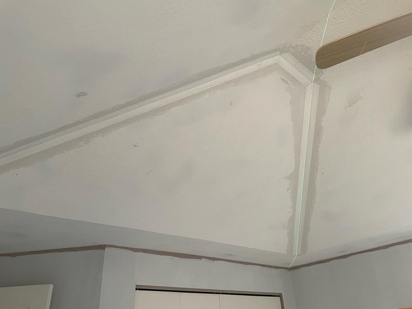 White ceiling with crown molding, joint taped, and corner trim.