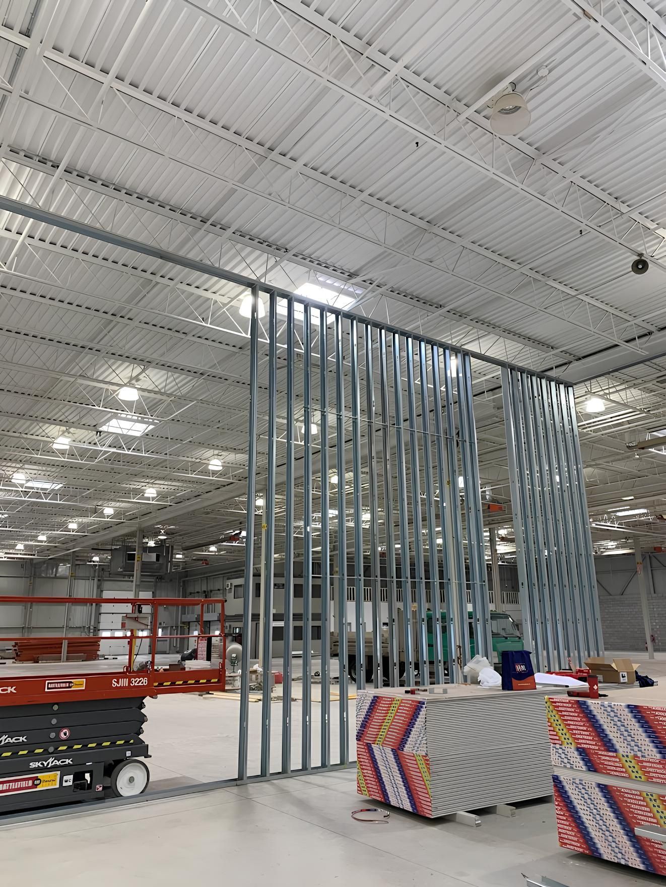 A large warehouse with a sliding glass door being built.