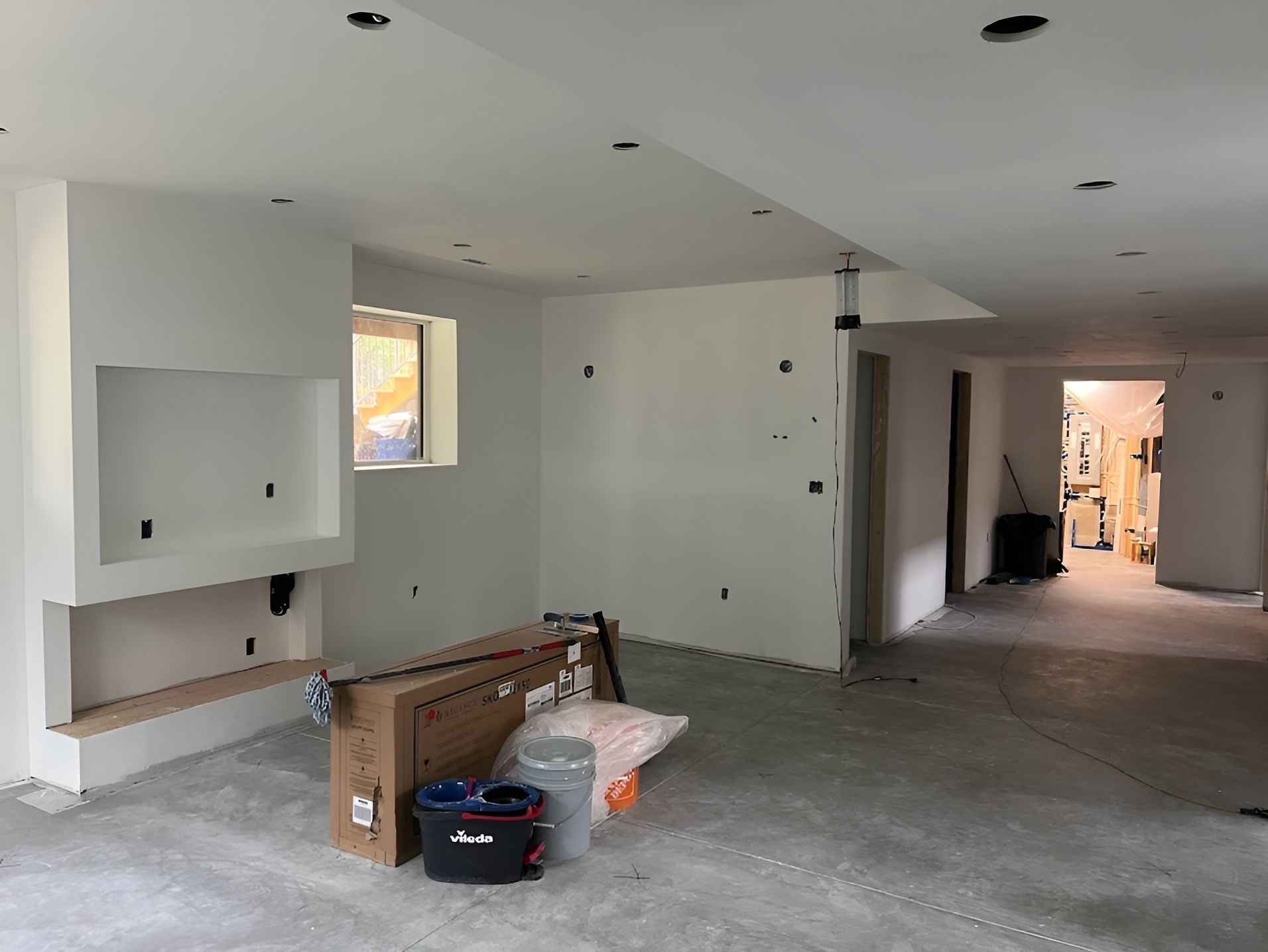 An empty room with white walls and a box on the floor.